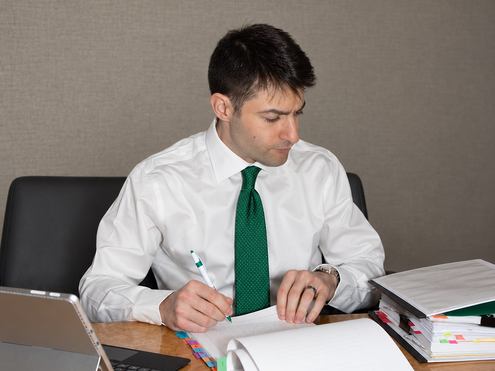Brian A. Klein reviewing a case file at the firm’s conference table